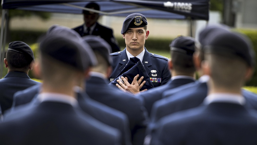 Air Force Capt. Michael F. Winter holds a ceremonial flag during a memorial retreat ceremony for fallen law enforcement members at Yokota Air Base, Japan, May 18, 2017. Winter is the commanding officer of the 374th Security Forces Squadron. Air Force photo by Airman 1st Class Donald Hudson