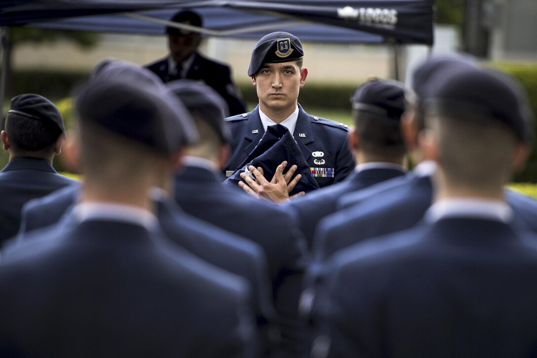 Air Force Capt. Michael F. Winter holds a ceremonial flag during a memorial retreat ceremony for fallen law enforcement members at Yokota Air Base, Japan, May 18, 2017. Winter is the commanding officer of the 374th Security Forces Squadron. Air Force photo by Airman 1st Class Donald Hudson