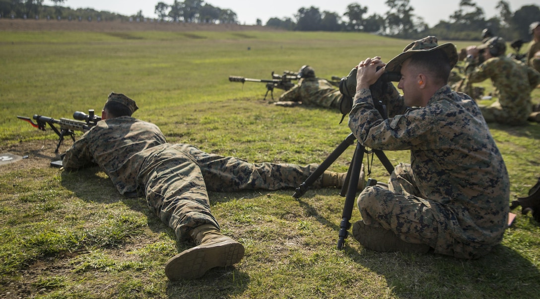 Staff Sgt. Martin Lucero (left) and Sgt. Johnathon Solinsky (right) calibrate an M40A6 sniper rifle alongside service members from the Australian Army, May 14, 2017, during a sniper competition at the Australian Army Skills at Arms Meeting, in Puckapunyal, Australia. The meet brings together service members from 20 countries to compete in more than 60 matches featuring a variety of weapons, including the pistol, rifle and machine gun. Lucero, a native of Denver, Colorado, is the head coach of the Marine Corps Action Shooting Team, based out of Marine Corps Base Quantico, Virginia. Solinsky, a native of Tucson, Arizona, is an instructor for the Marine Corps Rifle Team, also based out of MCB Quantico. (U.S. Marine Corps photo by Lance Cpl. Bernadette Wildes)