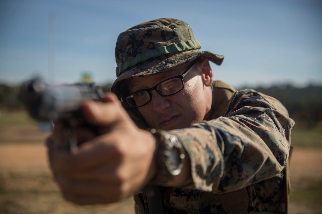 Sgt. Damian Knight practices quickly drawing his M9A1 service pistol, May 16, 2017, to prepare for a pistol match during a sniper competition for the Australian Army Skills at Arms Meeting in Puckapunyal, Australia. The meet, which brings together 20 countries, features pistol, machine gun, rifle and sniper competitions. Knight, a native of Saint Augustine, Florida, is a scout with 3rd Battalion, 4th Marine Regiment. The battalion is deployed to Australia in support of Marine Rotational Force Darwin. (U.S. Marine Corps photo by Lance Cpl. Bernadette Wildes)
