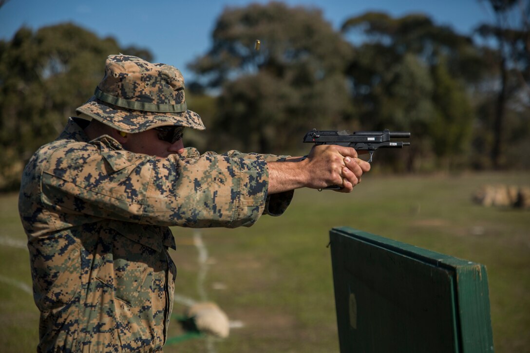 Sgt. Johnathon Solinsky fires his last shot during a pistol match, May 16, 2017, at the Australian Army Skills at Arms Meeting, in Puckapunyal, Australia. The meet brings together roughly 20 different countries to compete against each other. Solinsky, a native of Tucson, Arizona, is an instructor with the Marine Corps Rifle Team, based out of Marine Corps Base Quantico, Virginia. (U.S. Marine Corps photo by Lance Cpl. Bernadette Wildes)