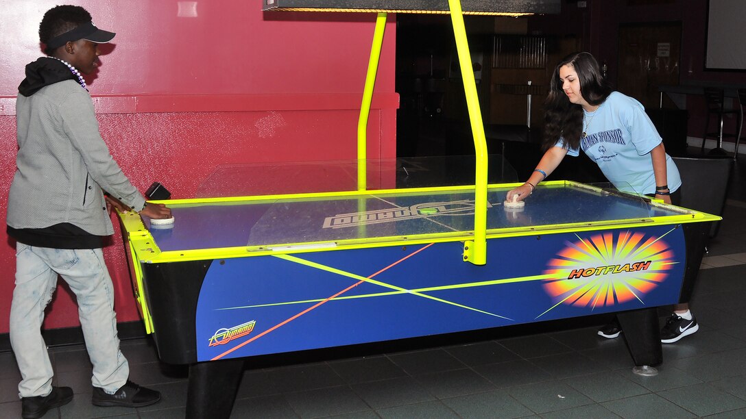 Nicholas Berry, Area 11 athlete, and Airman 1st Class Sierra Ward, 335th Training Squadron personnel student, play a game of air hockey during the Special Olympics Mississippi 2017 Summer Games May 20, 2017, on Keesler Air Force Base, Miss. While waiting for Berry’s events, he and his Airman sponsors hung out in the Vandenberg Commons and played games together. (U.S. Air Force photo by Senior Airman Jenay Randolph)