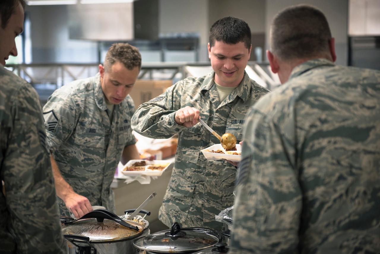 Airmen with the 182nd Airlift Wing, Illinois Air National Guard, scoop chili onto their plates at the wing’s ninth-annual chili cook-off in Peoria, Ill., May 17, 2017. Staff Sgt. Nicholas Freeman, an aerospace maintenance journeyman with the 182nd Aircraft Maintenance Squadron, Illinois Air National Guard, won first place in overall points, first place for consistency and tied for second place in the People’s Choice vote against 13 other chilies. (U.S. Air National Guard photo by Tech. Sgt. Lealan Buehrer)
