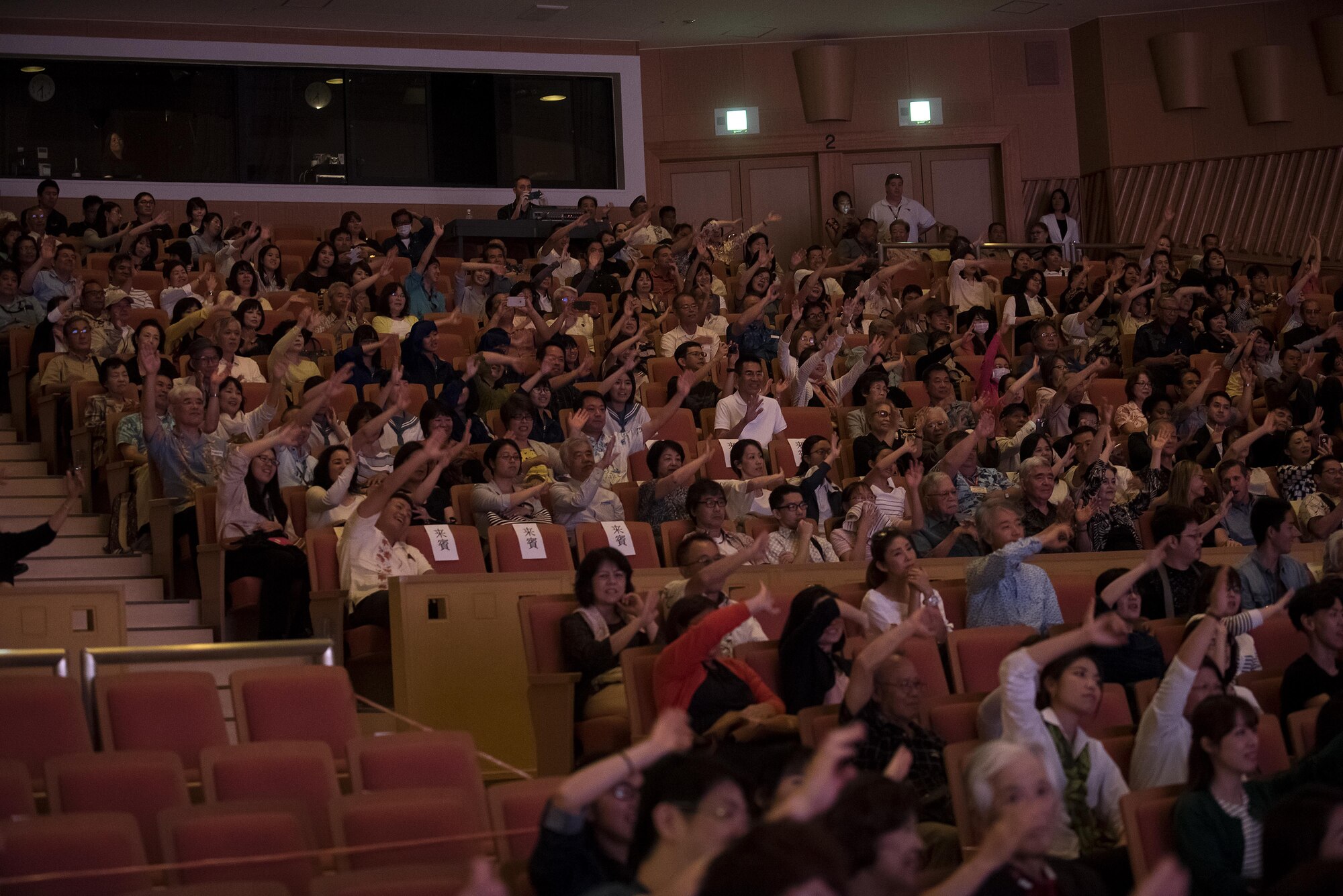Okinawan spectators wave their arms to the music at the U.S. Air Force Band of the Pacific-Asia, Pacific Trends concert at Tedako Hall in Urazoe City, Japan, May 24, 2017. Audience members enjoyed two hours of the Pacific Trends’ covers of popular American and Japanese rock songs. (U.S. Air Force photo by Senior Airman Corey Pettis)