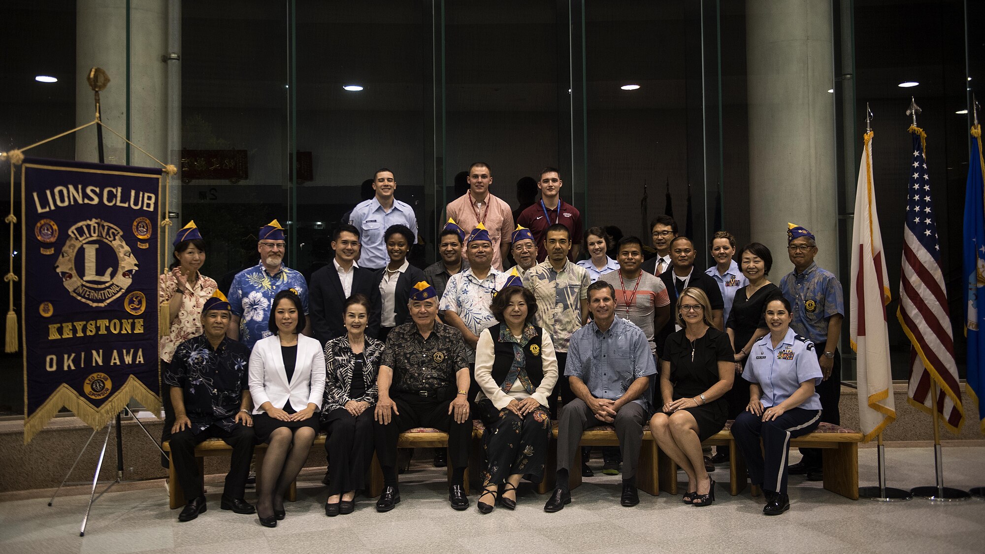U.S. Air Force Brig. Gen. Barry Cornish, 18th Wing commander, Lions Club Okinawa members, 18th Wing Public Affairs and Community Relations members and members of the U.S. Air Force Band of the Pacific-Asia, Pacific Trends pose for a photo after a concert at Tedako Hall in Urazoe City, Japan, May 24, 2017. The Lions Club worked with members of the 18th Wing to organize concerts for Okinawan residents. (U.S. Air Force photo by Senior Airman Corey Pettis)
