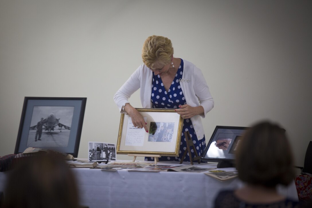 Linda Sanborn, wife of Maj. Gen. Russell A. Sanborn, the commanding general of 1st Marine Aircraft Wing, III Marine Expeditionary Force, points at a photo of herself in 1991, on the day she found her husband was still alive, while sharing her story with spouses at Camp Foster, Okinawa, Japan, May 23, 2017. During the event, Linda described the Marine Corps as a family that will be there during times of need. She is a native of DeLand, Florida. (U.S. Marine Corps photo by Lance Cpl. Andy Martinez)
