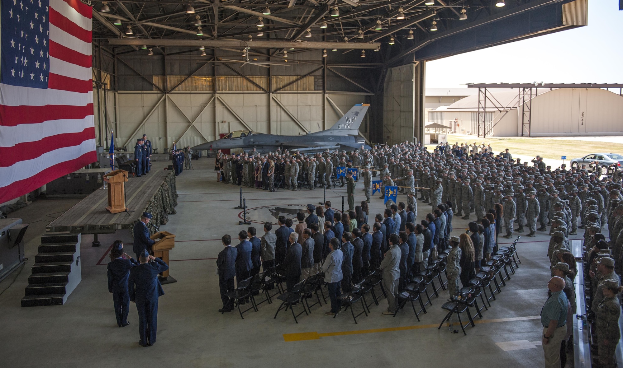 Members of the Wolf Pack stand at attention as the official party takes the stage during the 8th Fighter Wing change of command ceremony at Kunsan Air Base, Republic of Korea, May 25, 2017. Col. Todd A. Dozier relinquished command to Col. David G. Shoemaker. Shoemaker is the 57th commander to take the title of “Wolf.”  (U.S. Air Force photo by Senior Airman Colville McFee/Released)