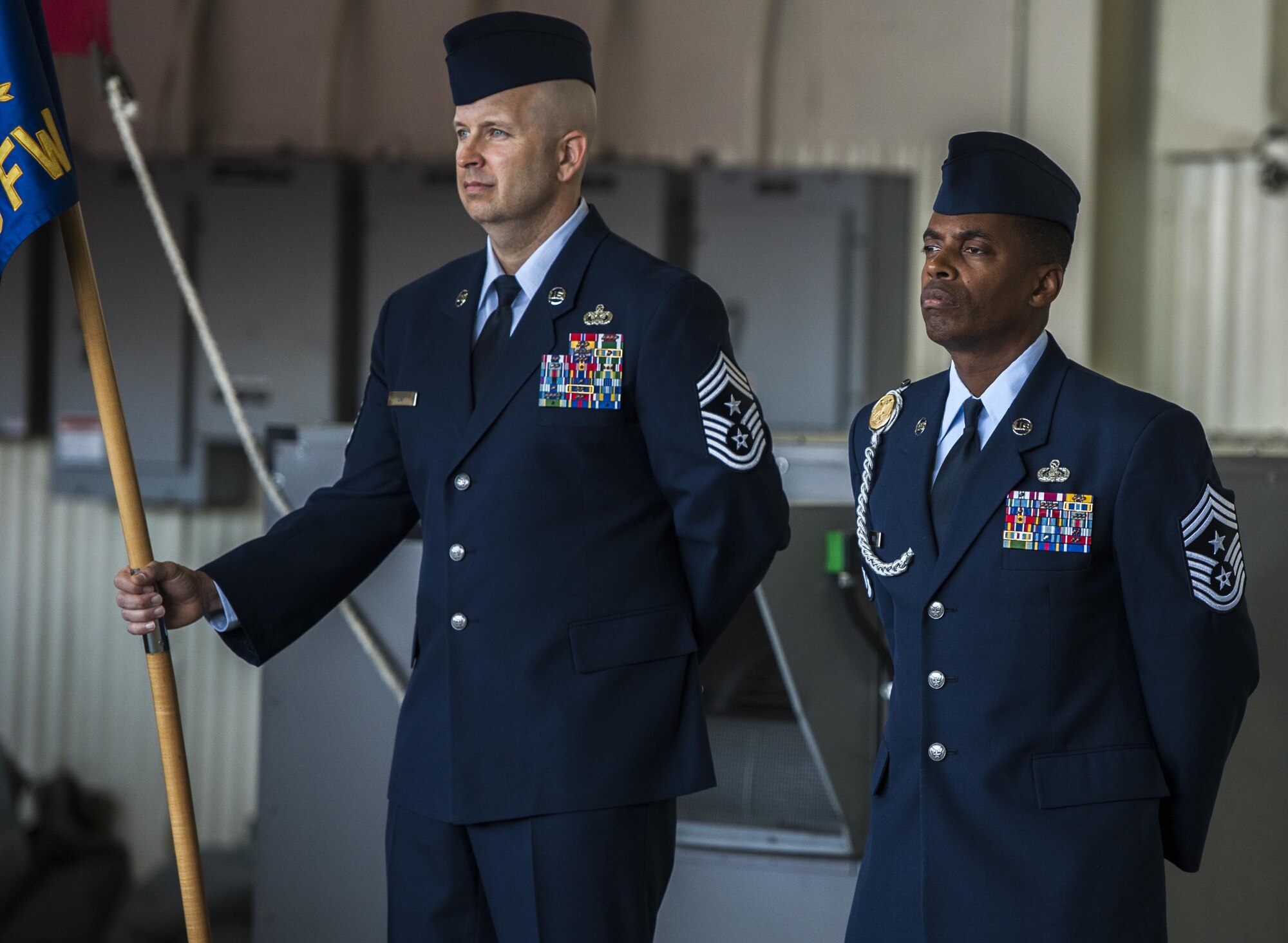 U.S. Air Force Chief Master Sergeant Charles C. Orf stands at parade rest next to Chief Master Sergeant Reiko Meekes at the 8th Fighter Wing change of command ceremony at Kunsan Air Base, Republic of Korea, May 25, 2017. Orf relinquished the position of 8th Fighter Wing command chief to Chief Master Sergeant Meekes, as the base transferred command from Wolf 56 to Wolf 57. (U.S. Air Force photo by Senior Airman Colville McFee/Released)