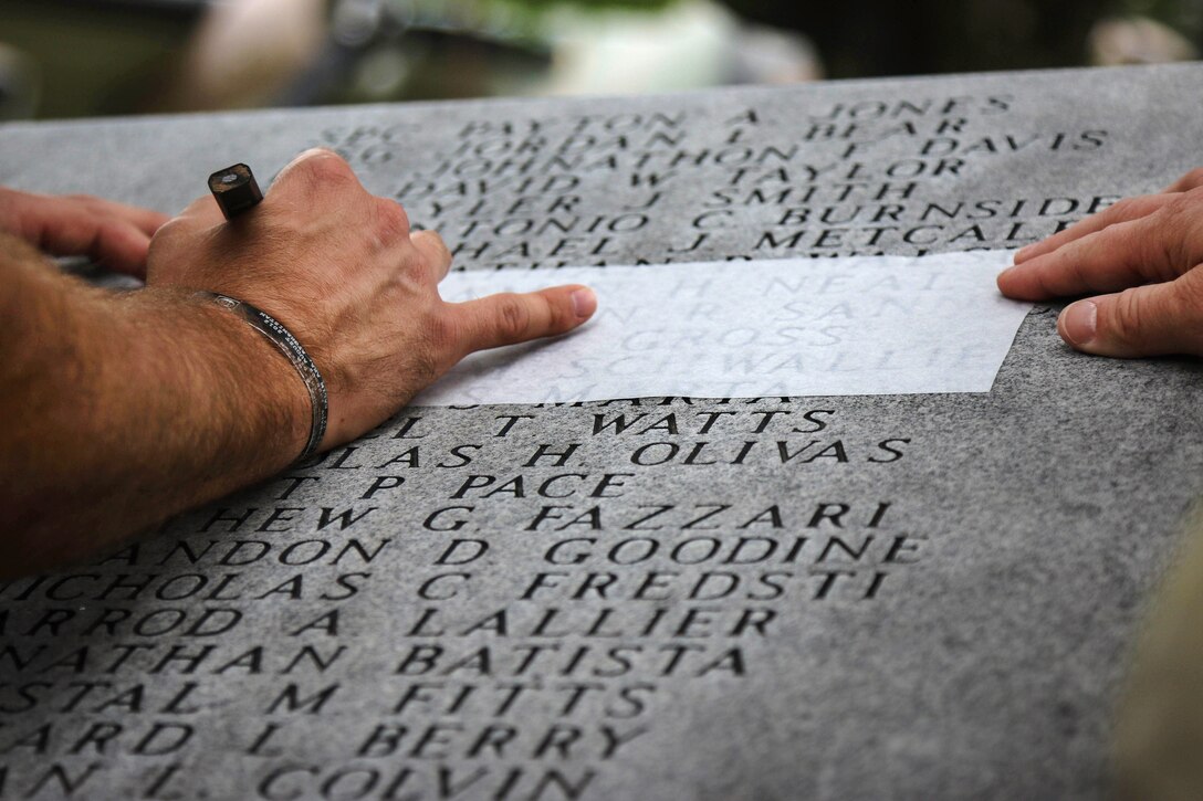 Gold Star families create rubbings of etched names on the Global War on Terrorism Memorial during the All American Week Memorial Service at the 82nd Airborne Division War Memorial Museum at Fort Bragg, N.C., May 24, 2017. The service allows troops, family members and friends to recognize the 5,021 paratroopers who died in combat and 236 paratroopers who died in training during the division’s century of service. Army photo by Sgt. Jessica Nassirian