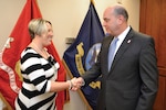 Dana Dallas, a packaging analyst and cold chain program manager for DLA Troop Support’s Medical supply chain, receives a coin from DLA Acquisition Director Matthew Beebe during his Nov. 9 visit. Dallas was also recognized with the Defense Department’s Packaging Excellence Award May 10 for her contributions to improved productivity and efficiency in packaging. Photo by Shawn J. Jones.