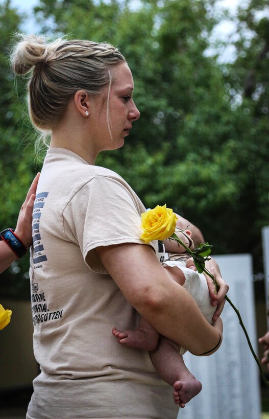 A Gold Star family member sheds tears as she waits to place a yellow rose on the Global War on Terrorism Memorial during the All American Week Memorial Service at the 82nd Airborne Division War Memorial Museum at Fort Bragg, N.C., May 24, 2017. Army photo by Sgt. Jessica Nassirian



