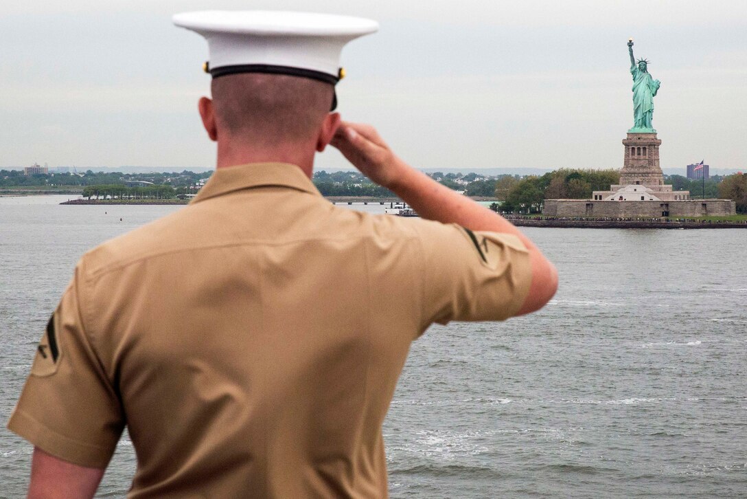 A Marine aboard the USS Kearsarge salutes the Statue of Liberty during the parade of ships as part of Fleet Week New York in New York , May 24, 2017. Marine Corps photo by Lance Cpl. Gloria Lepko