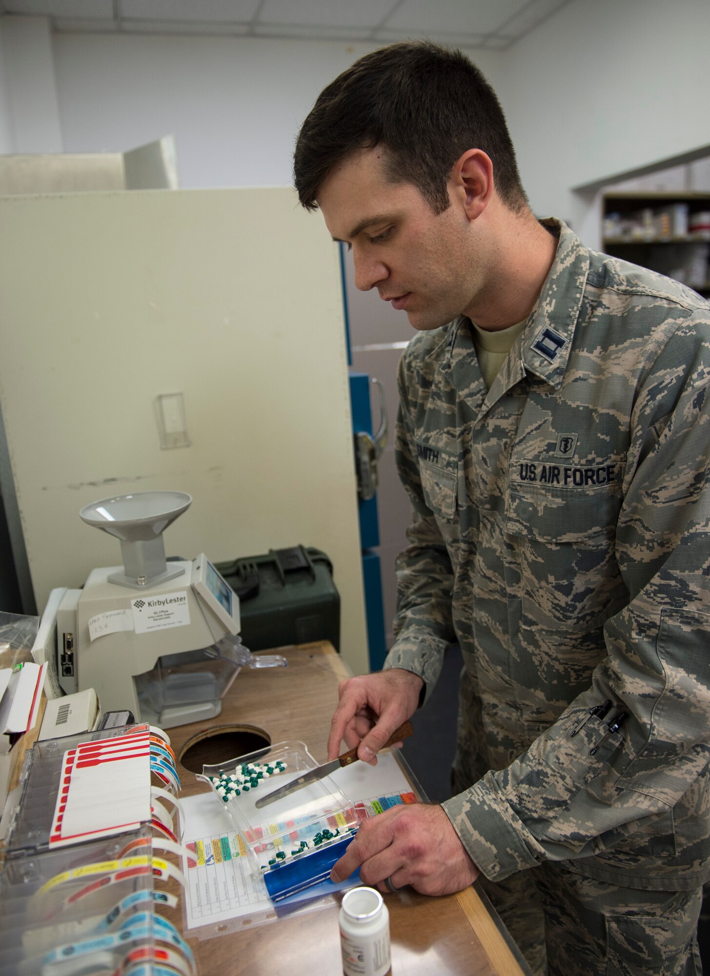U.S. Air Force Capt. Kyle Smith, a pharmacist with the 379th Expeditionary Medical Operations Squadron, counts out numbers of prescription medication at Al Udeid Air Base, Qatar, May 15, 2017. Airmen assigned to the pharmacy are responsible for managing all of the medication a patient brings from home, filling new prescriptions issued here and submitting a request if a medication is running low. (U.S. Air Force photo by Tech. Sgt. Amy M. Lovgren)