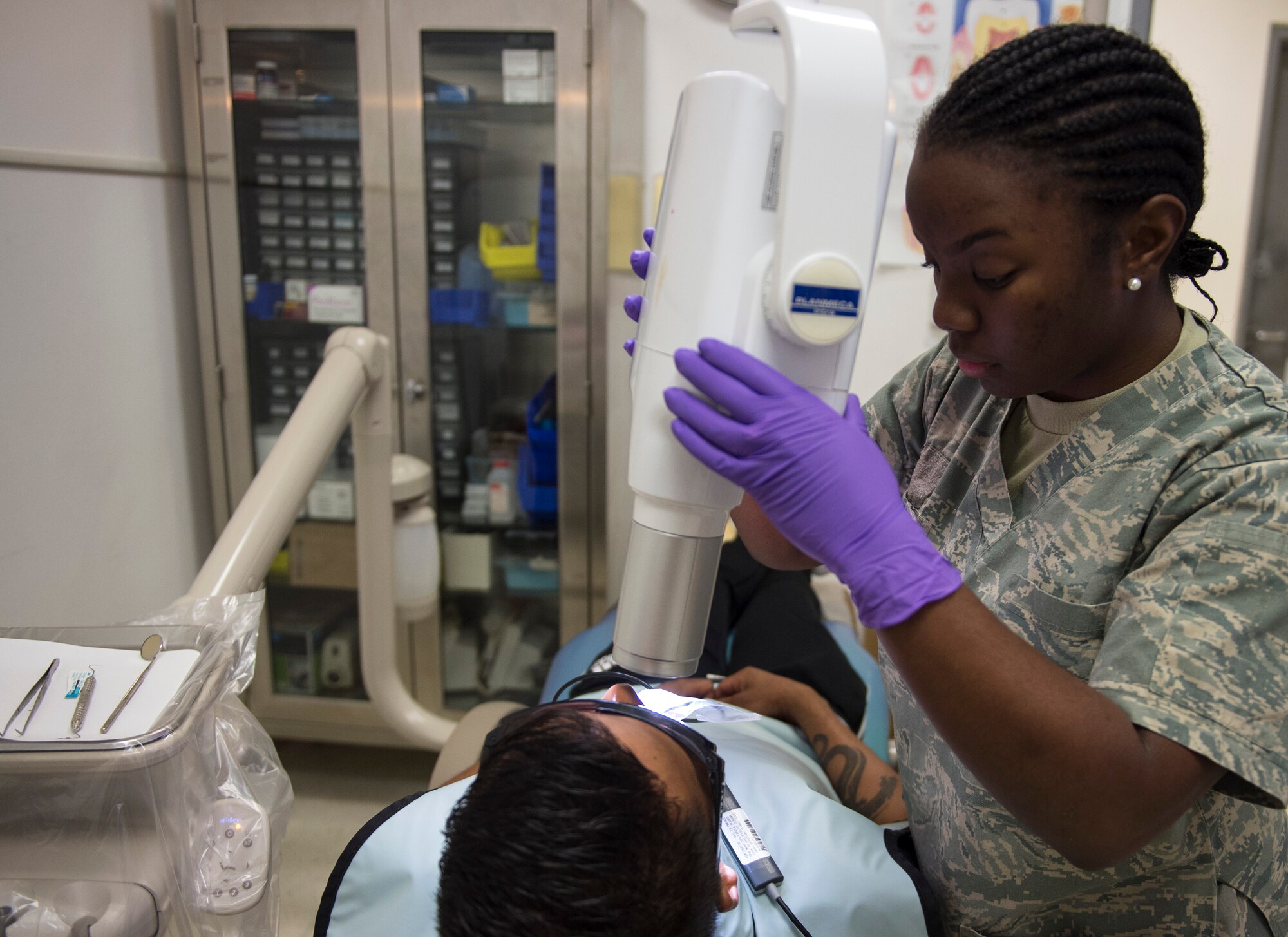 U.S. Air Force Senior Airman Breauna Robinson, a dental assistant with the 379th Expeditionary Medical Operations Squadron, prepares a patient for an x-ray at Al Udeid Air Base, Qatar, May 15, 2017. Airmen assigned to the dental section provide a wide range of services to include examinations, diagnosis and basic treatments of problems relating to the tooth or the mouth. (U.S. Air Force photo by Tech. Sgt. Amy M. Lovgren)