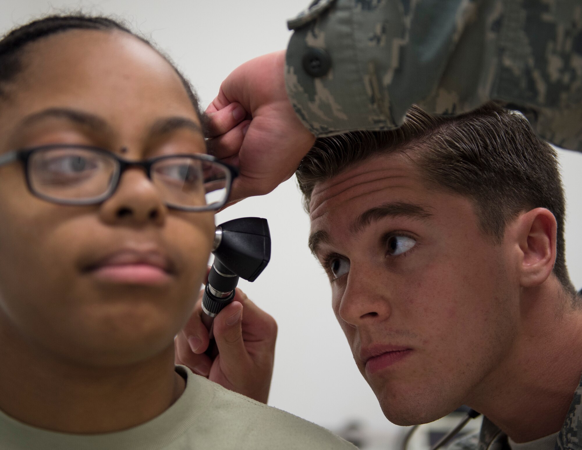 U.S. Air Force Senior Airman Tayler Tessitore, an emergency medical technician with the 379th Expeditionary Medical Operations Squadron, examines a patient’s ear in the primary care clinic at Al Udeid Air Base, Qatar, May 15, 2017. Emergency medical technicians assigned to the primary care clinic conduct a basic exam of the patient and report their findings to the doctor before they see the patient.  
(U.S. Air Force photo by Tech. Sgt. Amy M. Lovgren)