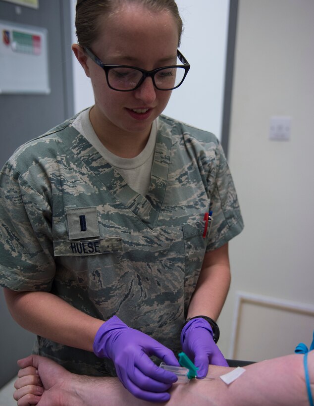 U.S. Air Force 1st Lt. Charisse Hulse, clinical nurse with the 379th Expeditionary Medical Operations Squadron, prepares to draw blood from a patient’s arm for lab testing at Al Udeid Air Base, Qatar, May 15, 2017. The blood samples will aid the medical providers with diagnosing and prescribing the proper treatment. 
(U.S. Air Force photo by Tech. Sgt. Amy M. Lovgren)