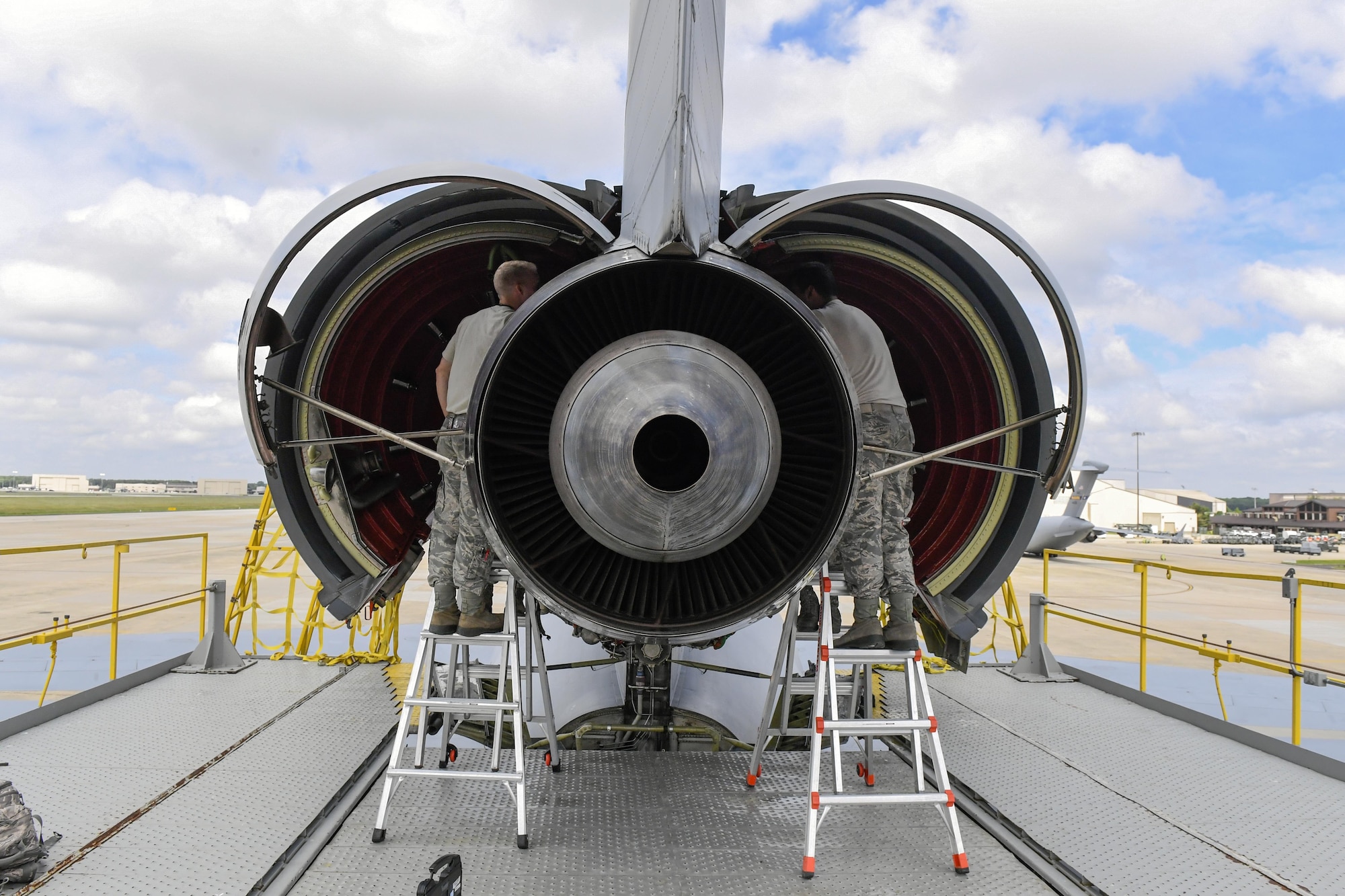 Airmen with the 605th Aircraft Maintenance Squadron perform repairs on fire detection hardware in the tail engine of a KC-10 Extender. Many of the KC-10 here are experiencing faulty fire detectors due to the age of the aircraft.