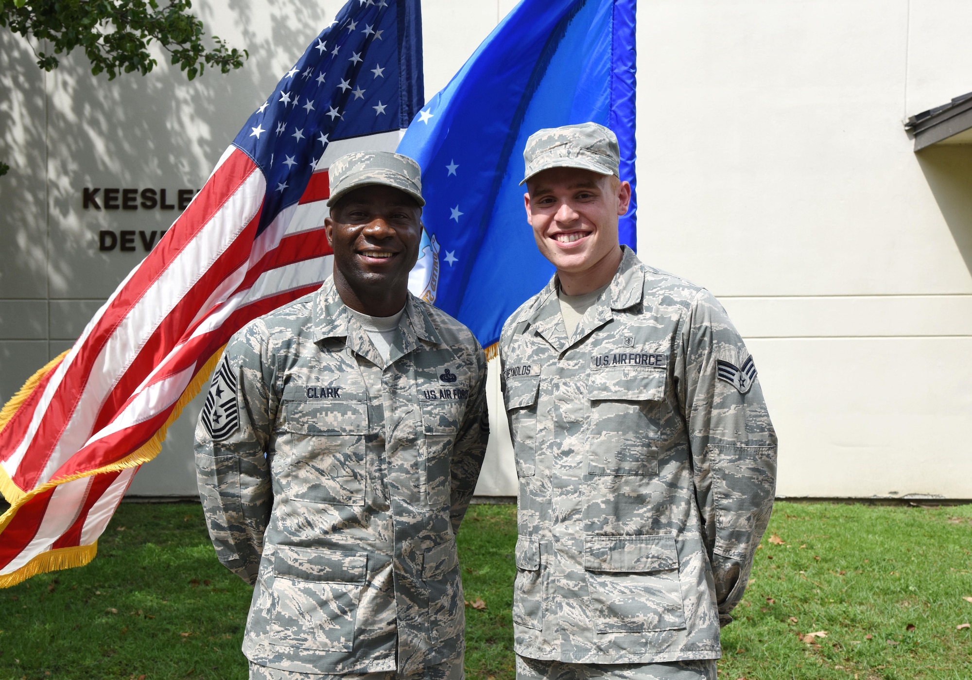 Senior Airman Brandon Reynolds, 81st Surgical Operations Squadron medical technician, poses for a photo with Chief Master Sgt. Vegas Clark, 81st Training Wing command chief, in front of the Professional Development Center May 17, 2017, on Keesler Air Force Base, Miss. He participated in the Command Chief for a Day program, which highlights outstanding enlisted performers from around the wing. Each Airman selected for the program spends a day shadowing Clark to learn what it takes to be a command chief. (U.S. Air Force photo by Kemberly Groue)

