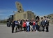 Local community members along with TEDX ABQ members take a photo in front of an active denial truck at Kirtland Air Force Base, New Mexico, May 17. Visitors spent the day learning about high power electromagnetics division technology which is often misrepresented via myth or social media. 