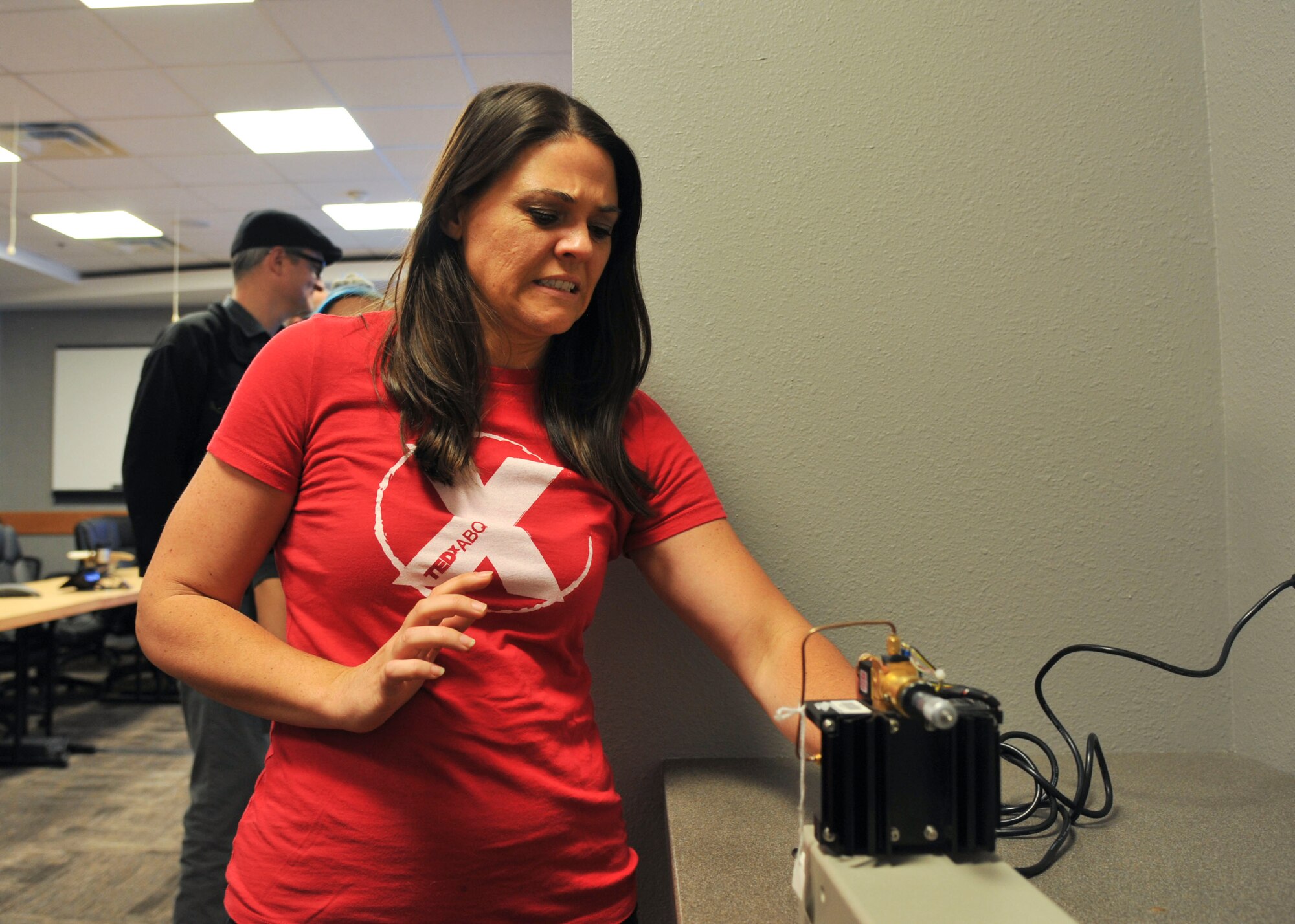 Beth Hemmerich, TEDx Albuquerque Adventures program coordinator, tests an active denial simulator at the Air Force Research Laboratory on Kirtland Air Force Base, New Mexico, May 17. The active denial system is a high power electromagnetic technology created to provide non-lethal and effective force protection. 