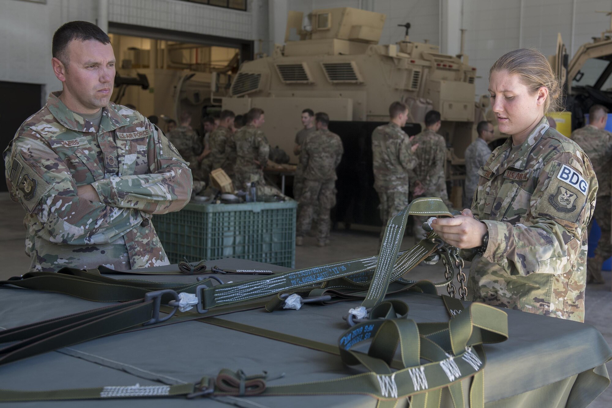 Master Sgt. Thomas Grubbs II, 820th Base Defense Group superintendent of standardizations and evaluations, watches as Airman 1st Class Megan Benoist, 822nd Base Defense Squadron fire team member, calls out deficiencies in a sling-load bundle during an Army Air Assault assessment, May 16, 2017, at Moody Air Force Base, Ga. Twenty-six Airmen attended the assessment which measured candidates’ aptitude in Air Assault operations, completion of equipment layouts, and rappelling. (U.S. Air Force photo by Tech. Sgt. Zachary Wolf)