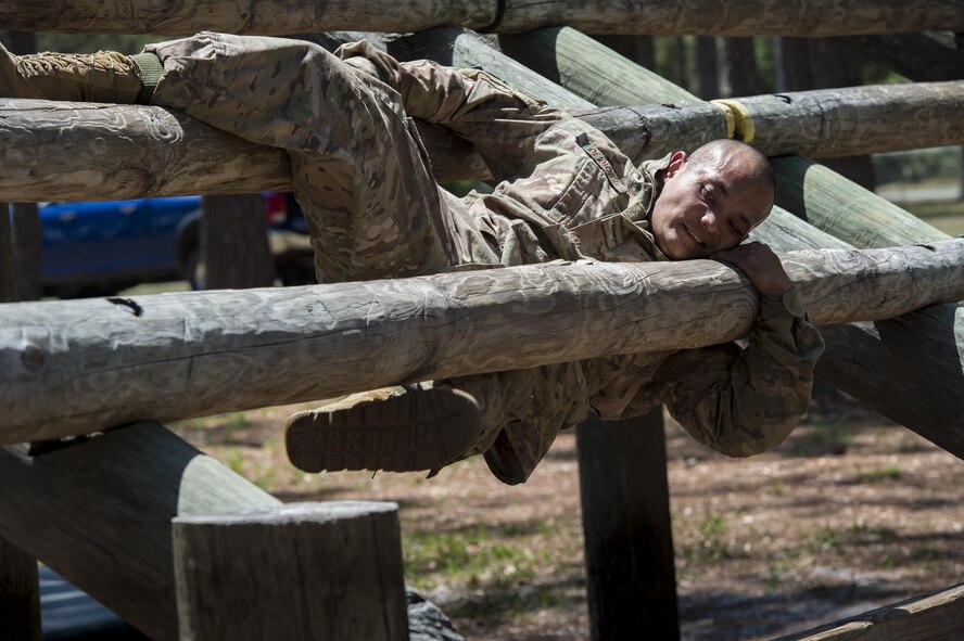 Staff Sgt. Adrian De Dios, 822nd Base Defense Squadron fire team leader, attempts a weaver obstacle during an Army Air Assault assessment, May 18, 2017, at Camp Blanding, Fla. Twenty-six Airmen attended the assessment which measured candidates’ aptitude in Air Assault operations, completion of equipment layouts, and rappelling. (U.S. Air Force photo by Tech. Sgt. Zachary Wolf)