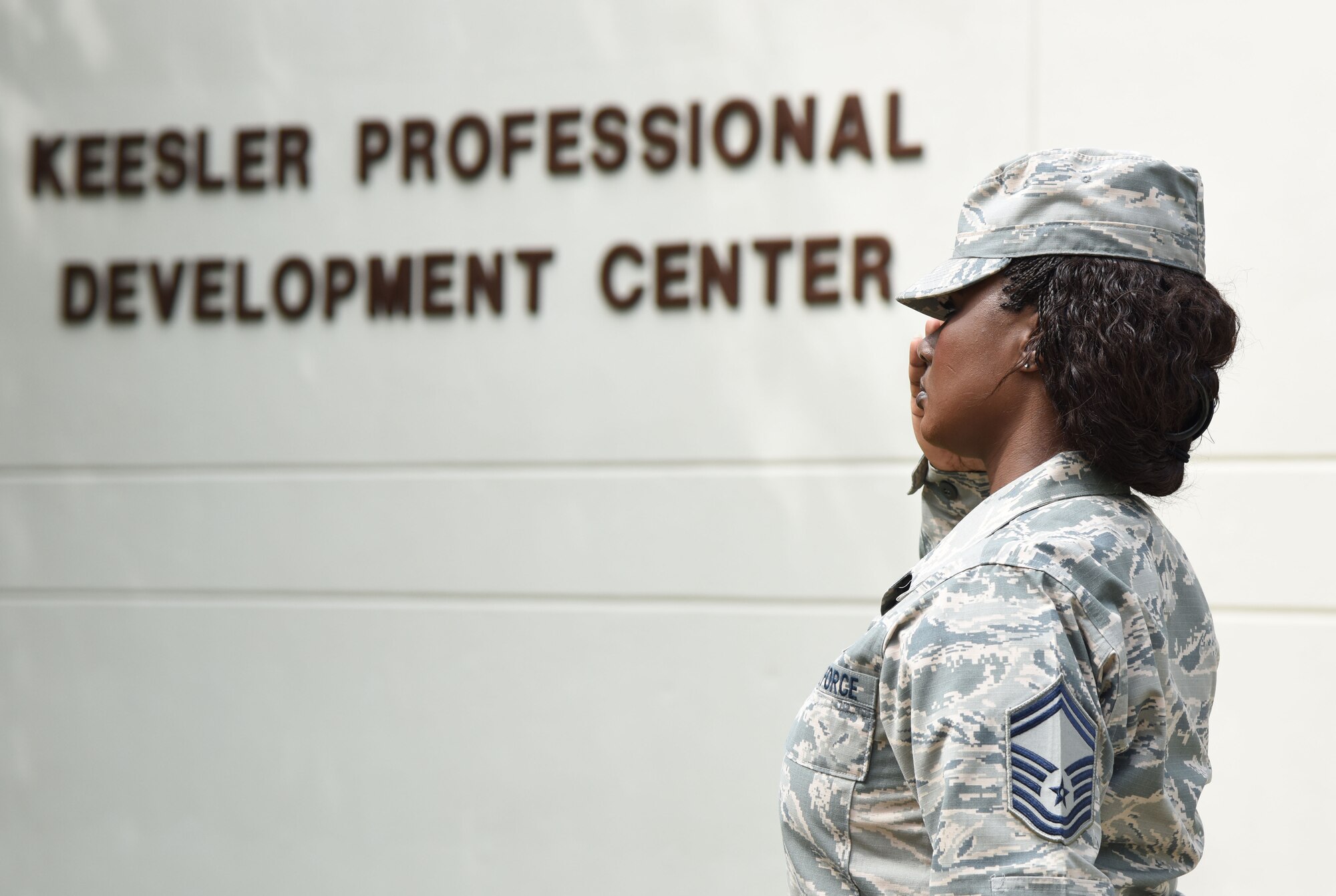 Senior Master Sgt. Tiffany Patterson, 81st Force Support Squadron career assistance advisor, renders a salute during the national anthem at the Professional Development Center’s grand reopening and ribbon cutting ceremony May 17, 2017, on Keesler Air Force Base, Miss. The renovated facility offers developmental opportunities and various courses that fit the needs of officers, enlisted, civilians and reservists. (U.S. Air Force photo by Kemberly Groue)