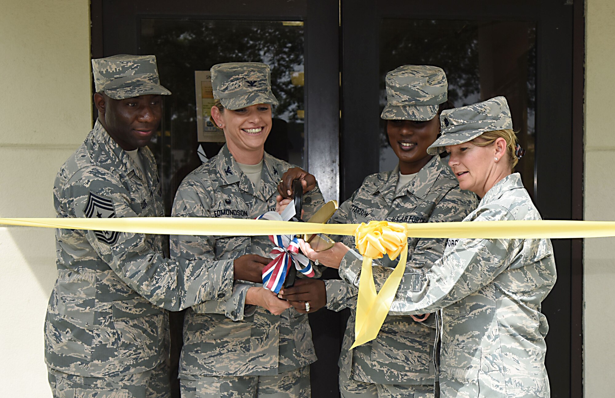 Base leadership and members of the 81st Force Support Squadron participate in a ribbon cutting ceremony during the Professional Development Center’s grand reopening ceremony May 17, 2017, on Keesler Air Force Base, Miss. The renovated facility offers developmental opportunities and various courses that fit the needs of officers, enlisted, civilians or reservists. (U.S. Air Force photo by Kemberly Groue)