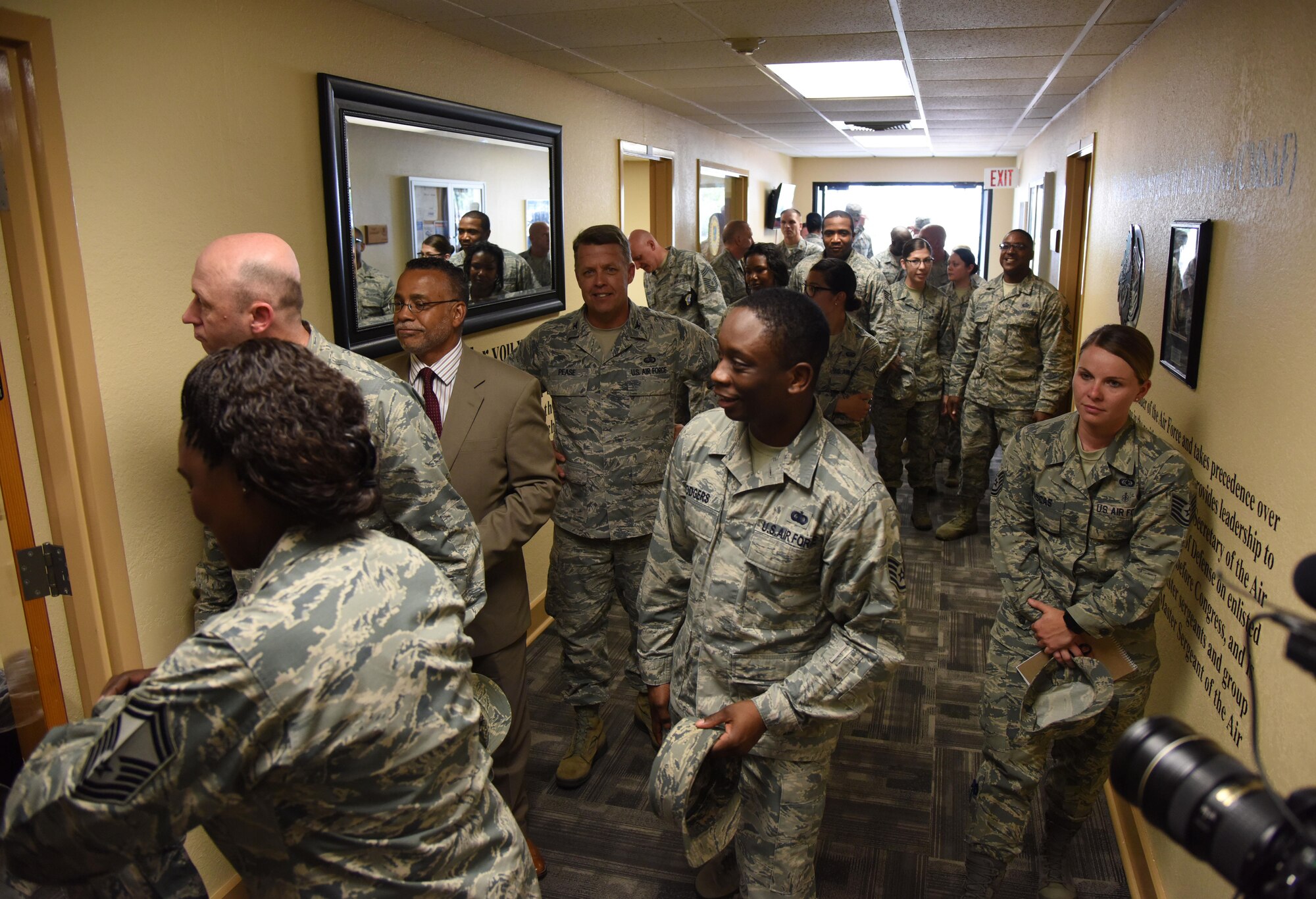 Keesler personnel fill the halls of the Professional Development Center during the grand reopening and ribbon cutting ceremony May 17, 2017, on Keesler Air Force Base, Miss. The renovated facility offers developmental opportunities and various courses that fit the needs of officers, enlisted, civilians or reservists. (U.S. Air Force photo by Kemberly Groue)