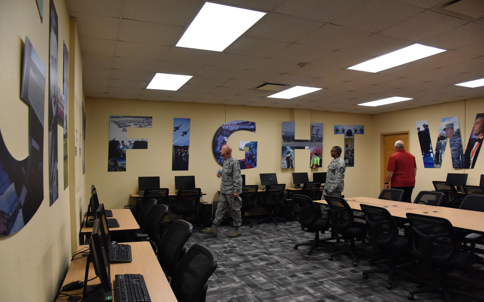 Keesler personnel view a renovated classroom inside the Professional Development Center during the grand reopening and ribbon cutting ceremony May 17, 2017, on Keesler Air Force Base, Miss. The facility offers developmental opportunities and various courses that fit the needs of officers, enlisted, civilians or reservists. (U.S. Air Force photo by Kemberly Groue)