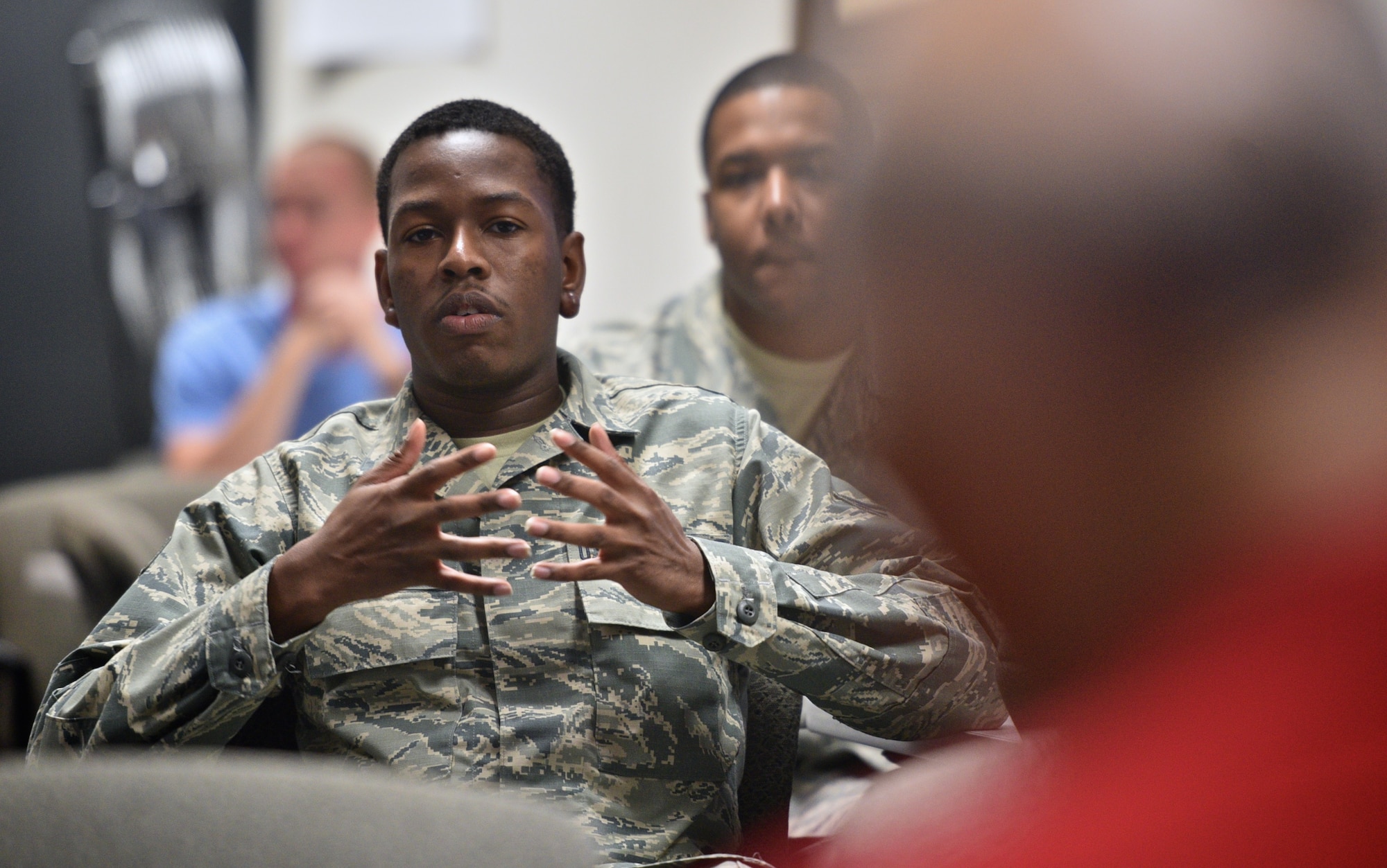 Senior Airman Andre Sanders,    932nd Civil Engineers Squadron, shares his own Tuskegee experience with  retired Lt. Col. Robert (Bob) Friend, a Tuskegee Airman May 7, 2017, Scott Air Force Base, Illinois. Sanders earned his private pilots license with Tuskegee Next. A program that provides opportunities to aviation careers for at-risk youth.  (U.S. Air Force photo by Tech. Sgt. Christopher Parr)