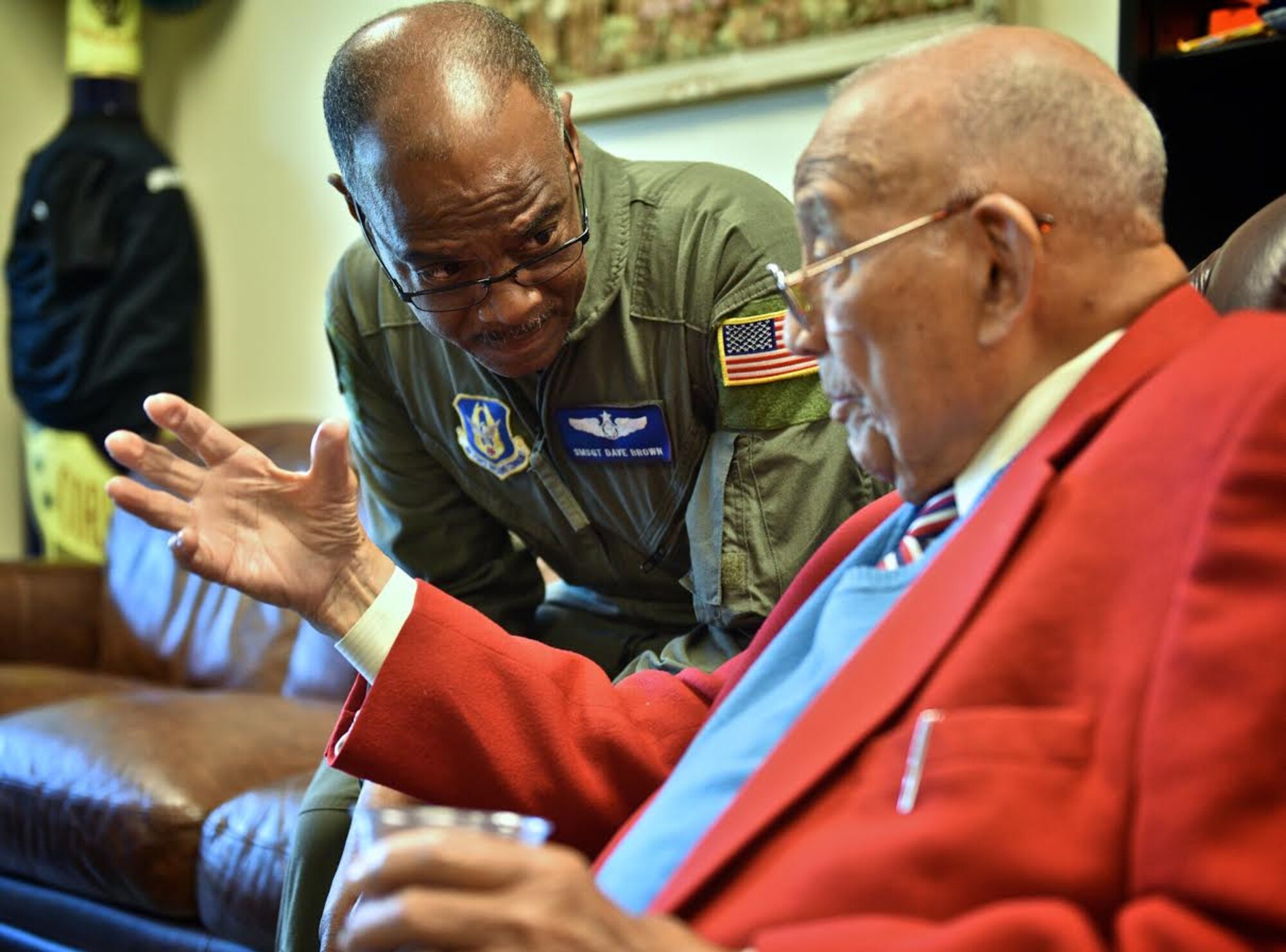 Senior Master Sgt. David Brown, C-40C instructor flight attendant with the 73rd Airlift Squadron listens to retired Lt. Col. Robert (Bob) Friend as the two chat about current and past race issues in the military, May 7, 2017, Scott Air Force Base, Illinois. Colonel Friend is one of 16 living Red Tale pilots from WWII and spent several days visiting with Airmen from the 932nd Airlift Wing (U.S. Air Force photo by Tech. Sgt. Christopher Parr)