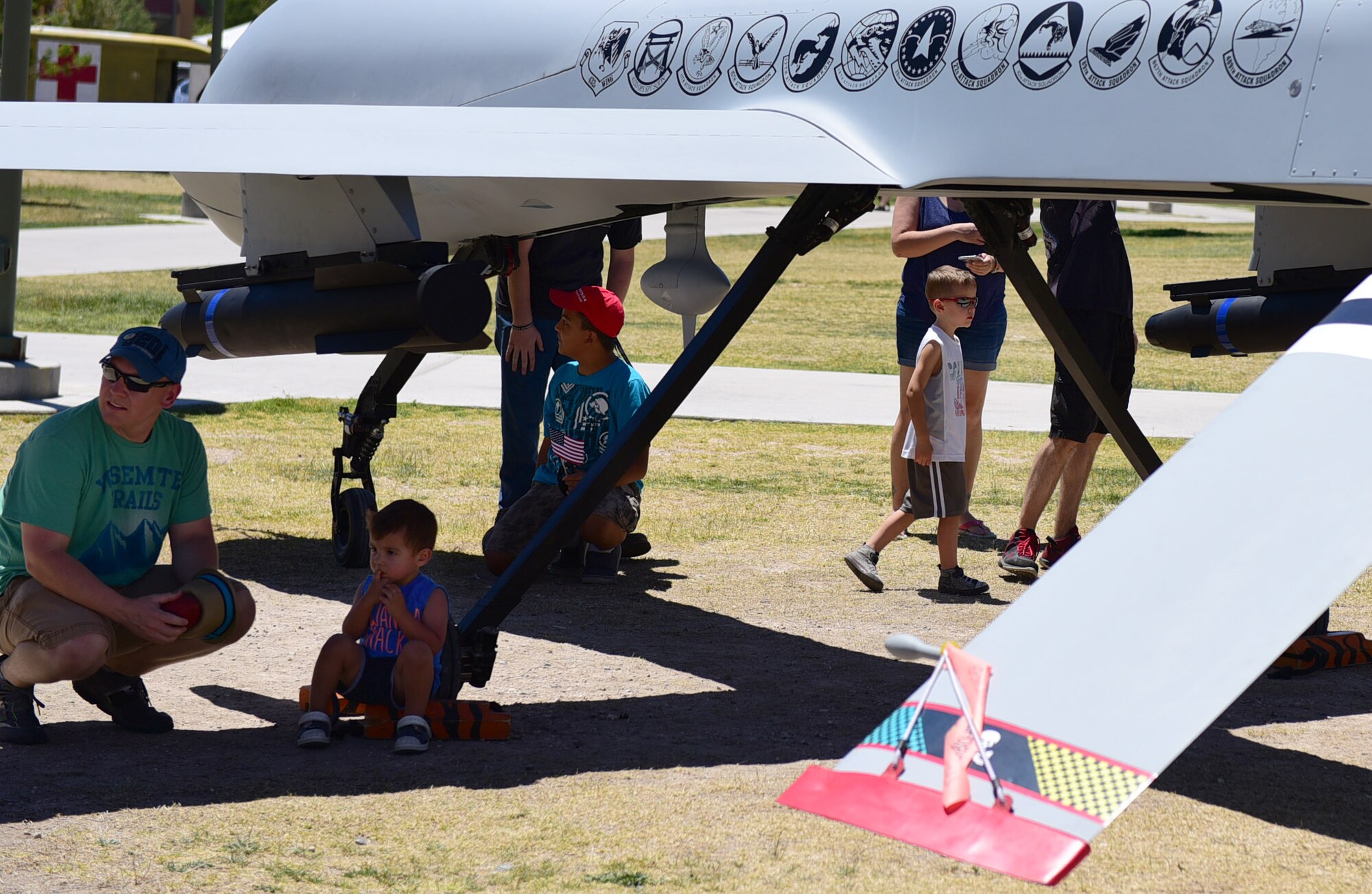 Veterans and their families admire the MQ-1 Predator during the American Patriot Festival May 20, 2017, in Las Vegas. The American Patriot Festival brought veterans and their families together to enjoy military displays, performances and a car show. (U.S. Air Force photo/Senior Airman Christian Clausen)