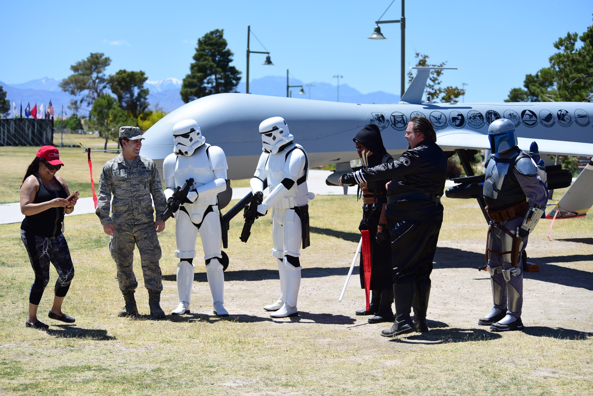 An MQ-1 Predator maintainer talks to locals dressed as members of the galactic empire during the American Patriot Festival May 20, 2017, in Las Vegas. The American Patriot Festival brought veterans and their families together to enjoy military displays, performances and a car show. (U.S. Air Force photo/Senior Airman Christian Clausen)