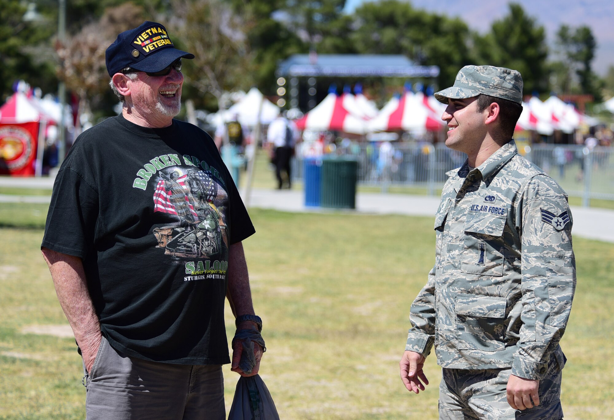 An MQ-1 Predator maintainer shares a laugh with a Vietnam veteran during the American Patriot Festival May 20, 2017, in Las Vegas. Veterans and their families gathered around the MQ-1 to ask questions and learn about the aircraft and its capabilities. (U.S. Air Force photo/Senior Airman Christian Clausen)