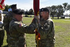 Army Col. Stephen Riley, right, 597th Transportation Brigade commander, hands the guidon to the new 841st Transportation Battalion commander, Lt. Col. Chad Blacketer, left, during a change of command ceremony at Joint Base Charleston May 19, 2017. The 841st Transportation Battalion's mission is to conduct surface deployment and redeployment distribution and water terminal operations to support and sustain the warfighter. 