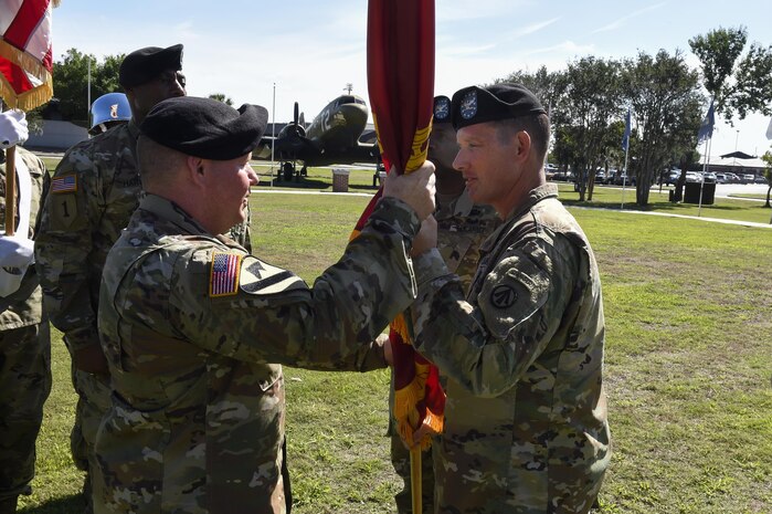Army Col. Stephen Riley, right, 597th Transportation Brigade commander, hands the guidon to the new 841st Transportation Battalion commander, Lt. Col. Chad Blacketer, left, during a change of command ceremony at Joint Base Charleston May 19, 2017. The 841st Transportation Battalion's mission is to conduct surface deployment and redeployment distribution and water terminal operations to support and sustain the warfighter. 