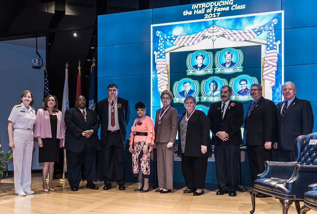 (From left) – Land and Maritime Commander Navy Rear Adm. Michelle Skubic, Acquisition Executive Roxanne Banks, Comptroller Oscar Mitchell representing Laurie Lipscomb, Donald Lushbaugh, Regina Westbrook, Retired Navy Rear Adm. Linda Bird, Susan McKee, Michael Souders representing his wife Barbara, Deputy Chief of Staff Don Schulze and Deputy Commander James McClaugherty gather for a group photo during the DLA Land and Maritime Hall of Fame induction of the Class of 2017.