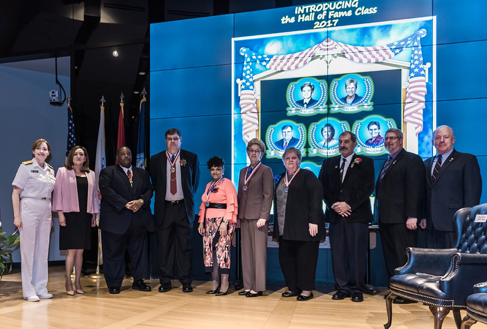 (From left) – Land and Maritime Commander Navy Rear Adm. Michelle Skubic, Acquisition Executive Roxanne Banks, Comptroller Oscar Mitchell representing Laurie Lipscomb, Donald Lushbaugh, Regina Westbrook, Retired Navy Rear Adm. Linda Bird, Susan McKee, Michael Souders representing his wife Barbara, Deputy Chief of Staff Don Schulze and Deputy Commander James McClaugherty gather for a group photo during the DLA Land and Maritime Hall of Fame induction of the Class of 2017.