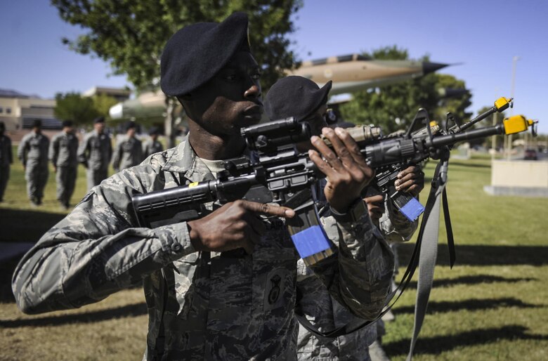 Senior Airman Anthony Flynn, 99th Security Forces Squadron leader, performs a 21 gun salute to honor fallen law enforcement officers during a ceremony for National Police Week at Nellis Air Force Base, Nev., May 19, 2017. Throughout the week, Defenders and local law enforcement participated in a variety of events at Nellis and Creech AFB. (U.S. Air Force photo by Senior Airman Kevin Tanenbaum/Released)