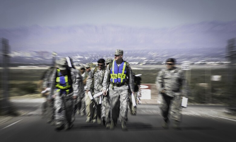 Defenders from the 99th and 799th Security Forces Squadrons participate in a ruck march during National Police Week at Nellis Air Force Base, Nev. May 16, 2017. Defenders, along with local law enforcement used the week to come together in a series of events to commemorate. (U.S. Air Force photo by Senior Airman Kevin Tanenbaum/Released)