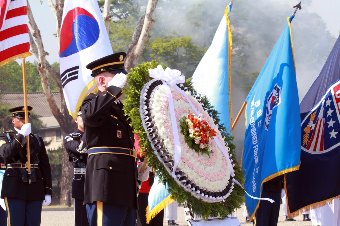 Members of the United Nations Command Honor Guard take part in a 21-gun salute
