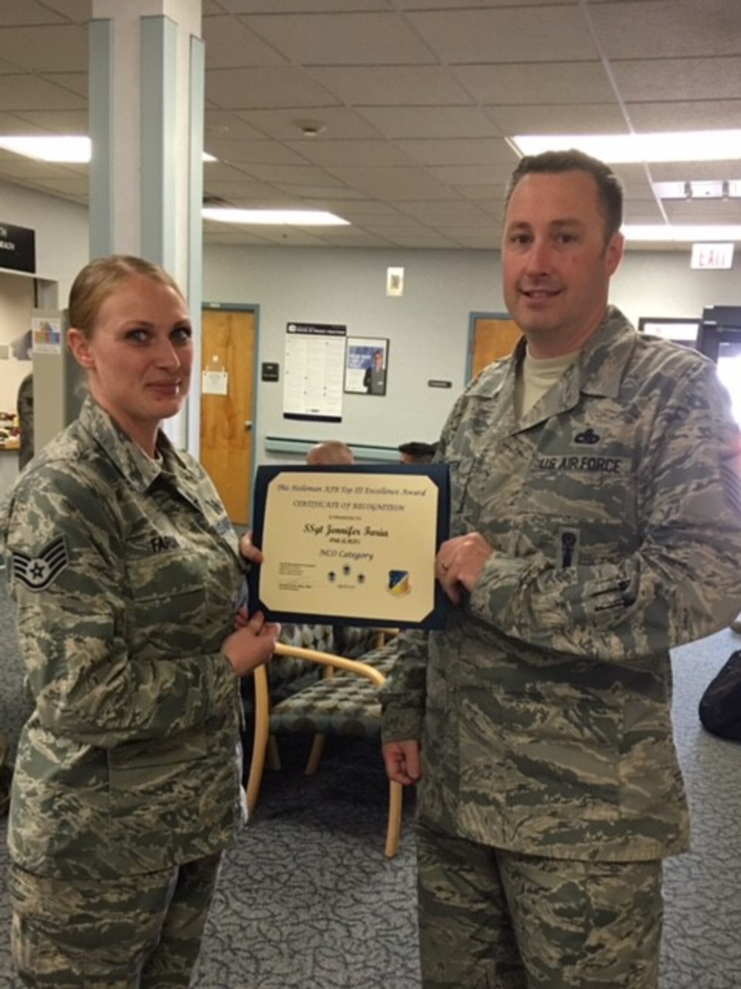 Staff Sgt. Jennifer Faria, 49th Aerospace Medical Squadron public health technician, is presented the Top III non-commissioned officer award for April from Master Sgt. Timothy Gatten, 54th Aircraft Maintenance Squadron first sergeant and Top III President, at Holloman Air Force Base on May 24, 2017. During the month of April, Faria inspected 25 food and public facilities, identified 20 discrepancies that required attention, essentially protecting approximately 18 thousand people from foodborne illness outbreaks. Faria is dedicated to mentoring Airmen, and briefed the First Term Airman Center on topics including The Enlisted Force Structure and on the Airman Comprehensive Assessment. (Courtesy photo)