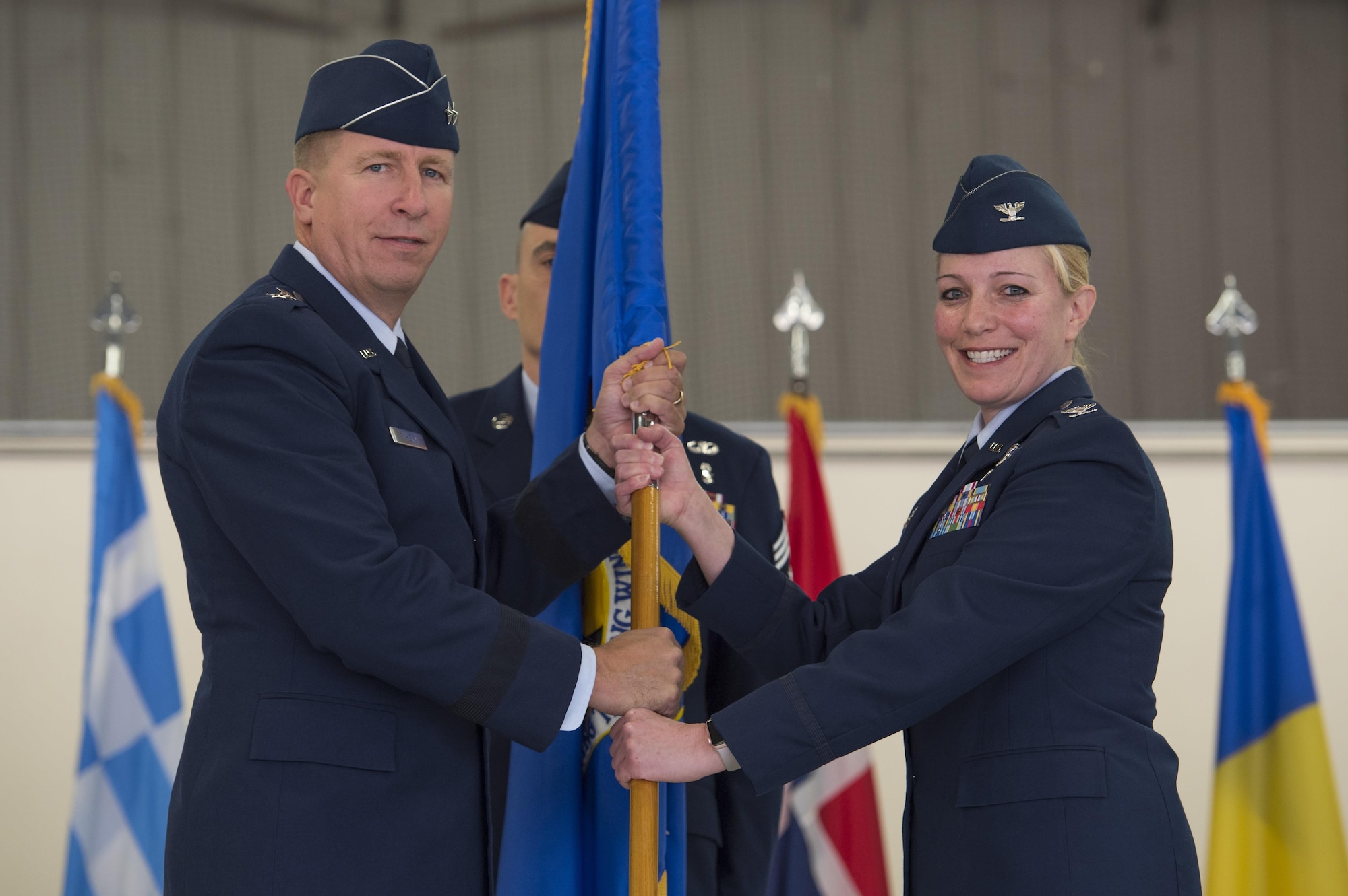 Maj. Gen. Patrick Doherty, 19th Air Force commander, passes the ceremonial guidon to Col. Andrea Themely, incoming 80th Flying Training Wing commander, during the 80th Flying Training Wing Change of Command ceremony at Sheppard Air Force Base, Texas, May 25, 2017. Themely previously served at Sheppard as commander of the 89th Flying Training Squadron from 2012 to 2014. (U.S. Air Force photo by Staff Sgt. Kyle E. Gese)