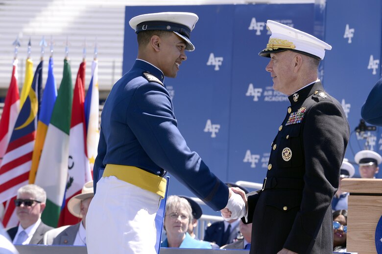 Newly-commissioned 2nd Lt. Brodie Hicks shakes hands with Chairman of the Joint Chiefs of Staff Marine Gen. Joseph Dunford during the U.S. Air Force Academy's Class of 2017 Graduation Ceremony at Falcon Stadium, May 24, 2017. (Air Force photo/ Mike Kaplan) 