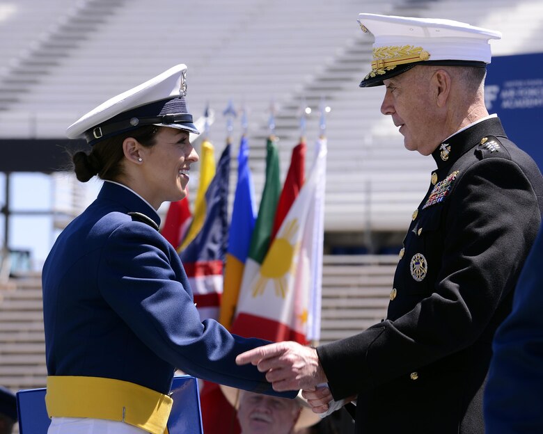 Newly-commissioned 2nd Lt. Marlene Flescher shakes hands with Chairman of the Joint Chiefs of Staff Marine Gen. Joseph Dunford during the U.S. Air Force Academy's Class of 2017 Graduation Ceremony at Falcon Stadium, May 24, 2017. (U.S. Air Force photo/ Mike Kaplan) 