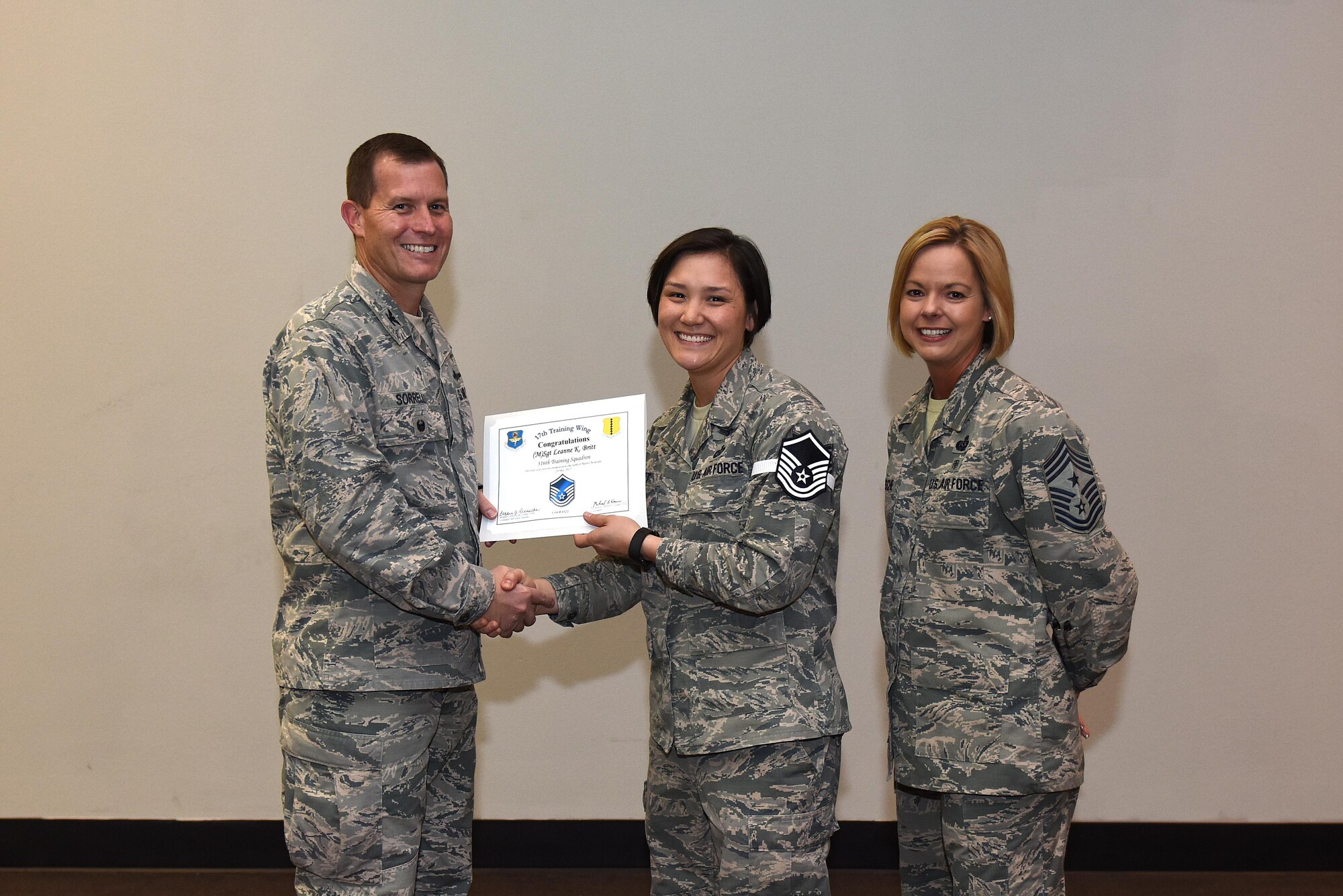 U.S. Air Force Master Sgt. select Leanne Britt, 316th Training Squadron, receives her certificate of selection from Col. Jeffrey Sorrell, 17th Training Wing vice commander, and Chief Master Sergeant Bobbie Riensche, 17th Training Wing command chief, during the Master Sergeant Release Party at the Event Center on Goodfellow Air Force Base, Texas, May 24, 2017.
