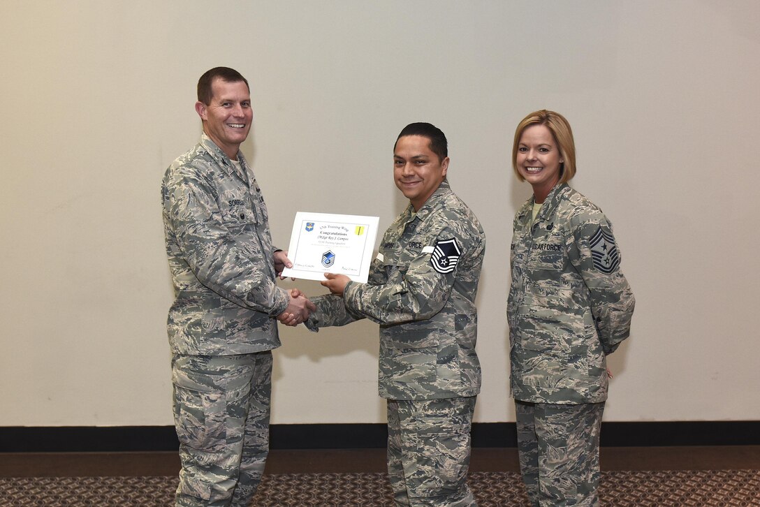 U.S. Air Force Master Sgt. select Roy Campos, 312th Training Squadron, receives his certificate of selection from Col. Jeffrey Sorrell, 17th Training Wing vice commander, and Chief Master Sergeant Bobbie Riensche, 17th Training Wing command chief, during the Master Sergeant Release Party at the Event Center on Goodfellow Air Force Base, Texas, May 24, 2017.