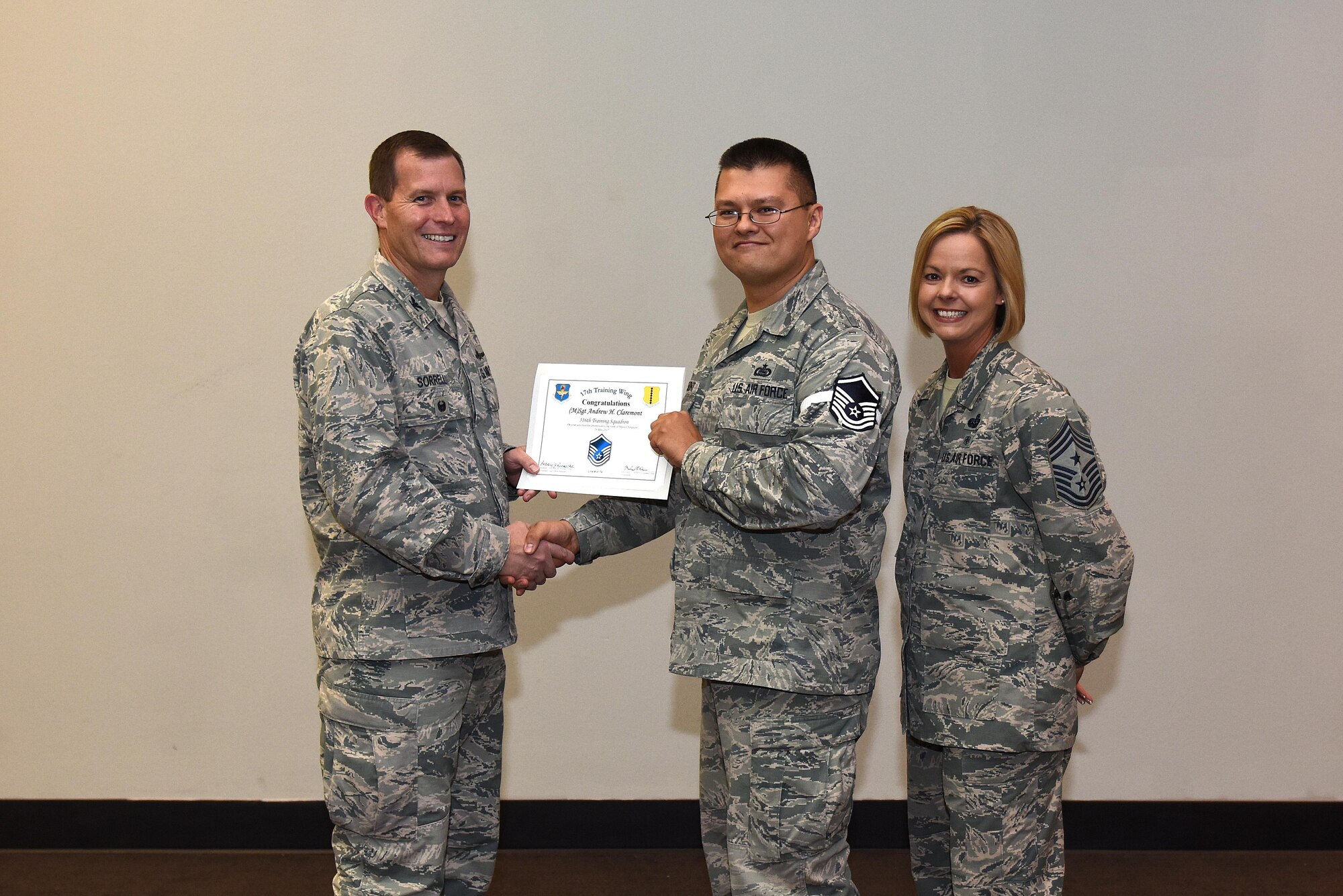 U.S. Air Force Master Sgt. select Andrew Claremont, 316th Training Squadron, receives his certificate of selection from Col. Jeffrey Sorrell, 17th Training Wing vice commander, and Chief Master Sergeant Bobbie Riensche, 17th Training Wing command chief, during the Master Sergeant Release Party at the Event Center on Goodfellow Air Force Base, Texas, May 24, 2017.