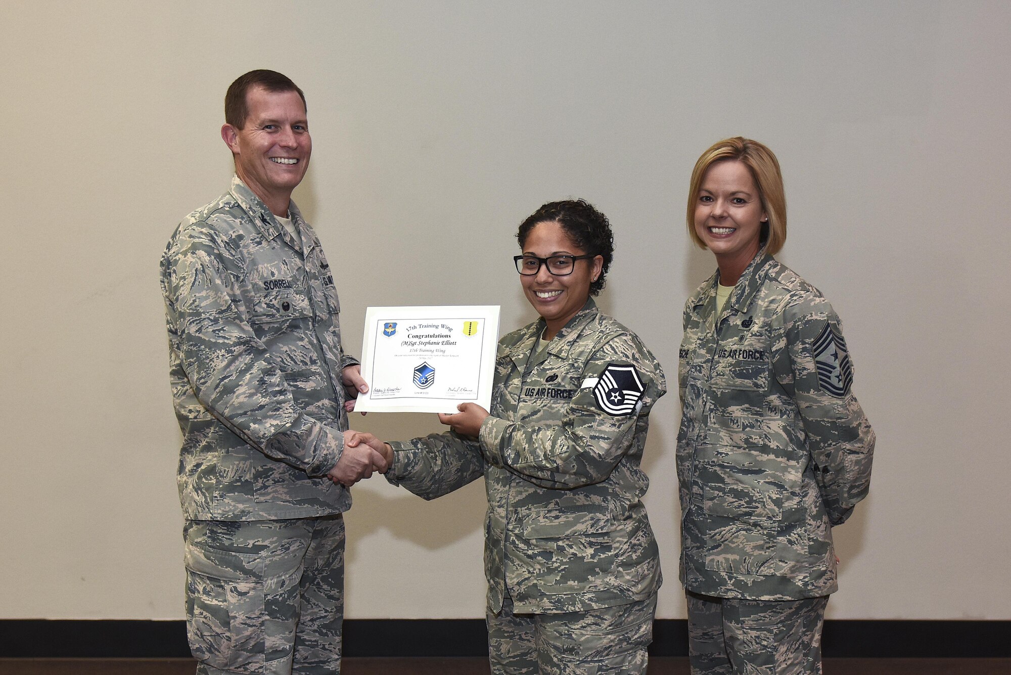 U.S. Air Force Master Sgt. select Stephanie Elliot, 17th Training Wing, receives her certificate of selection from Col. Jeffrey Sorrell, 17th Training Wing vice commander, and Chief Master Sergeant Bobbie Riensche, 17th Training Wing command chief, during the Master Sergeant Release Party at the Event Center on Goodfellow Air Force Base, Texas, May 24, 2017.